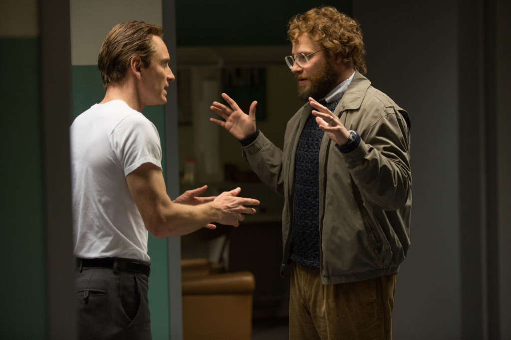In this image released by Universal Pictures, Michael Fassbender, left, as Steve Jobs, and Seth Rogen as Steve Wozniak, appear in a scene from the film, "Steve Jobs." The movie releases in U.S. theaters on Friday, Oct. 9, 2015. (Francois Duhamel/Universal Pictures via AP)